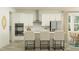 Modern kitchen boasts white cabinets, stainless steel appliances, and a breakfast bar with seating for a contemporary living at 18477 Serene Lake Loop, Lutz, FL 33548