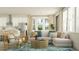 Inviting living room featuring a comfortable sofa, complemented by an open concept kitchen and a sun-filled sitting area at 18477 Serene Lake Loop, Lutz, FL 33548