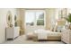 Inviting main bedroom with a woven headboard, neutral color palette, and ample natural light for a peaceful ambiance at 18477 Serene Lake Loop, Lutz, FL 33548