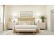 Serene main bedroom featuring a textured headboard, soft lighting, and coordinated decor for a relaxing retreat at 18477 Serene Lake Loop, Lutz, FL 33548
