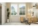 Bright office space featuring a stylish desk, chair, decor, and light colored walls at 18477 Serene Lake Loop, Lutz, FL 33548