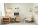 Cozy home office with desk, modern decor, and chair, lit by a floor lamp at 18477 Serene Lake Loop, Lutz, FL 33548
