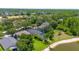 Aerial view of home showcasing pool and manicured lawn overlooking a pond at 19412 Heritage Harbor, Lutz, FL 33558