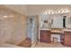 Bright bathroom featuring a glass block shower and double vanity with granite counters at 19412 Heritage Harbor, Lutz, FL 33558