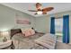 Inviting bedroom with soft colors, a plush bedspread, and a decorative painting at 19412 Heritage Harbor, Lutz, FL 33558