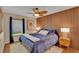 Modern bedroom with wood-paneled accent wall, large bed, and a window with natural light at 19412 Heritage Harbor, Lutz, FL 33558