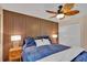 Comfortable bedroom with a unique wood accent wall and stylish bedside lamps at 19412 Heritage Harbor, Lutz, FL 33558