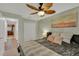 Comfortable bedroom with wood floors, a ceiling fan, and a view of the kitchen at 19412 Heritage Harbor, Lutz, FL 33558