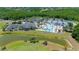 An aerial view of the community pool and clubhouse, surrounded by a lake and golf course at 19412 Heritage Harbor, Lutz, FL 33558