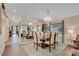 Bright dining room with a mirrored wall, stylish chandelier, and seating for six at 19412 Heritage Harbor, Lutz, FL 33558