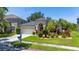 Charming single-story home featuring a well-manicured lawn and beautiful landscaping at 19412 Heritage Harbor, Lutz, FL 33558