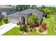 A well-maintained single-story home with a lush, landscaped front yard and a two car garage at 19412 Heritage Harbor, Lutz, FL 33558