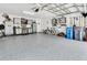 Well-organized garage featuring epoxy flooring, cabinets and a work bench at 19412 Heritage Harbor, Lutz, FL 33558