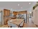 Bright kitchen boasts wooden cabinets, tile backsplash, stainless steel appliances, and island with seating at 19412 Heritage Harbor, Lutz, FL 33558