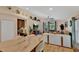 Bright kitchen with island and seating, opens to cozy living area with stylish decor and furnishings at 19412 Heritage Harbor, Lutz, FL 33558