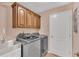 Laundry room with modern washer and dryer, cabinets, and sink, providing convenience and functionality at 19412 Heritage Harbor, Lutz, FL 33558