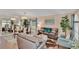 Open living room with modern furniture and decor, featuring a dining area with mirrored wall at 19412 Heritage Harbor, Lutz, FL 33558