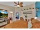 Bedroom with attached office/bathroom; neutral decor and plenty of natural light creating a comfortable space at 19412 Heritage Harbor, Lutz, FL 33558