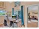 Bright office space featuring a large desk and slider to patio, with living room view at 19412 Heritage Harbor, Lutz, FL 33558