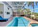 Relaxing screened-in pool area with brick trim and lush tropical landscaping at 19412 Heritage Harbor, Lutz, FL 33558