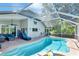 Inviting pool area with lounge seating, a ceiling fan, and screened enclosure at 19412 Heritage Harbor, Lutz, FL 33558