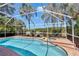 Sparkling pool area with a screened enclosure and scenic water views at 19412 Heritage Harbor, Lutz, FL 33558