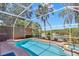 Inviting pool and hot tub area with screened enclosure and lush scenery at 19412 Heritage Harbor, Lutz, FL 33558