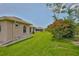 Backyard with green grass and garden beds at 2316 Lyndhurst Dr, Sun City Center, FL 33573