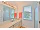 Bright bathroom featuring a spacious vanity, large mirror, and walk-in shower at 2316 Lyndhurst Dr, Sun City Center, FL 33573