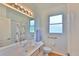 Accessible bathroom with grab bars, featuring a large mirror and spacious layout at 2316 Lyndhurst Dr, Sun City Center, FL 33573