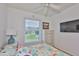Bright bedroom with a view, features coastal decor and a light color palette at 2316 Lyndhurst Dr, Sun City Center, FL 33573