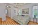 Cozy bedroom boasts light wood floors, arched entryway, and beach-themed accents at 2316 Lyndhurst Dr, Sun City Center, FL 33573