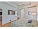 Bright bedroom features wood floors, a large window, and ceiling fan at 2316 Lyndhurst Dr, Sun City Center, FL 33573