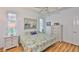 Bright bedroom featuring coastal decor, light wood floors, and a serene atmosphere at 2316 Lyndhurst Dr, Sun City Center, FL 33573