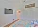 Comfortable bedroom with a wall-mounted TV, double closet, and charming decor at 2316 Lyndhurst Dr, Sun City Center, FL 33573