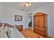 Comfortable bedroom showcasing a daybed, armoire, and warm wood tones at 2316 Lyndhurst Dr, Sun City Center, FL 33573