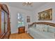 Bright bedroom features a ceiling fan, wood floors, a window, and a large wardrobe at 2316 Lyndhurst Dr, Sun City Center, FL 33573