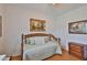 Cozy bedroom featuring a daybed, classic decor, and warm hardwood floors at 2316 Lyndhurst Dr, Sun City Center, FL 33573