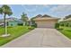 Attractive single-story home with a pristine driveway and well-maintained landscaping at 2316 Lyndhurst Dr, Sun City Center, FL 33573