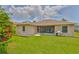 Rear exterior view of the home and manicured backyard at 2316 Lyndhurst Dr, Sun City Center, FL 33573