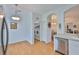 Kitchen area with stainless steel dishwasher, adjacent to the laundry room with white washer and dryer at 2316 Lyndhurst Dr, Sun City Center, FL 33573