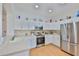 This kitchen features white cabinets, stainless steel appliances, and ample counter space for cooking and entertaining at 2316 Lyndhurst Dr, Sun City Center, FL 33573