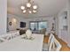 Bright open-concept living area with white trim, wood floors, and sliding glass doors to the outdoor space at 2316 Lyndhurst Dr, Sun City Center, FL 33573