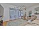 Living room with sliding doors to the patio and view into the Primary Bedroom at 2316 Lyndhurst Dr, Sun City Center, FL 33573