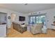 Cozy living room with sliding doors, TV, hardwood floors, and views to other rooms at 2316 Lyndhurst Dr, Sun City Center, FL 33573