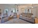 Bright and airy living room with hardwood floors, ceiling fan, and comfortable seating at 2316 Lyndhurst Dr, Sun City Center, FL 33573