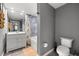 Bathroom featuring shower-tub combo and a single sink vanity with a gray color scheme at 2410 W Azeele St # 214, Tampa, FL 33609