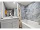 Modern bathroom featuring marble blue tile in the shower-tub combo and white vanity at 2410 W Azeele St # 214, Tampa, FL 33609