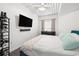 Bright bedroom features a ceiling fan, large window, and a flat-screen TV at 2410 W Azeele St # 214, Tampa, FL 33609