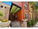 Charming entrance with colorful accents, a protective awning, and well-maintained landscaping creating an inviting welcome at 2410 W Azeele St # 214, Tampa, FL 33609